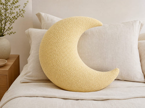 The Crescent moon pillow, full crescent shape on a bed